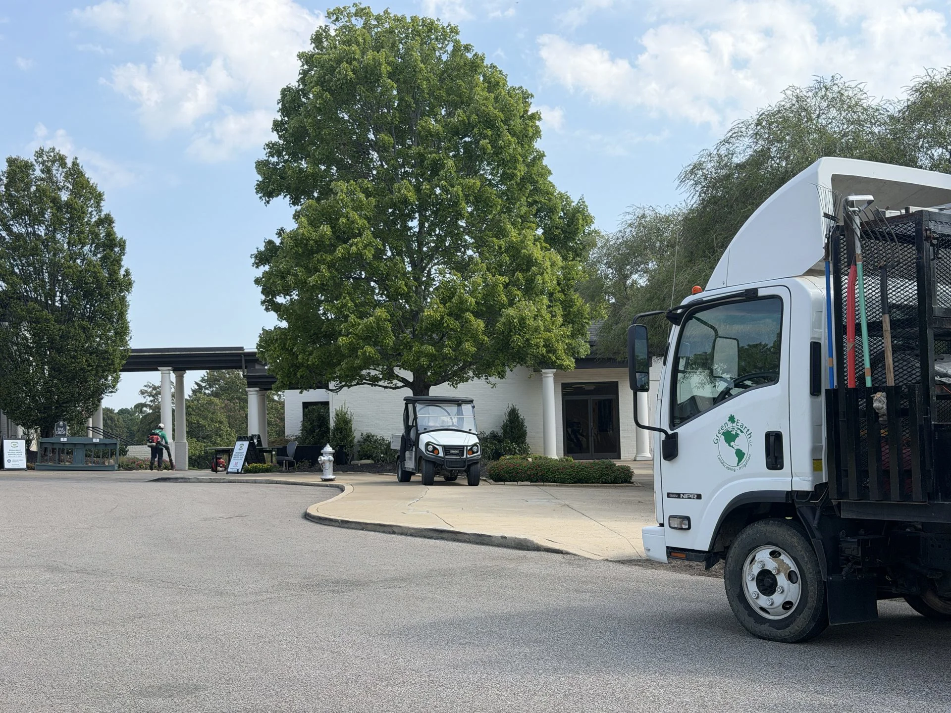Green Earth LLC landscape truck servicing a commercial property entrance in Memphis, TN
