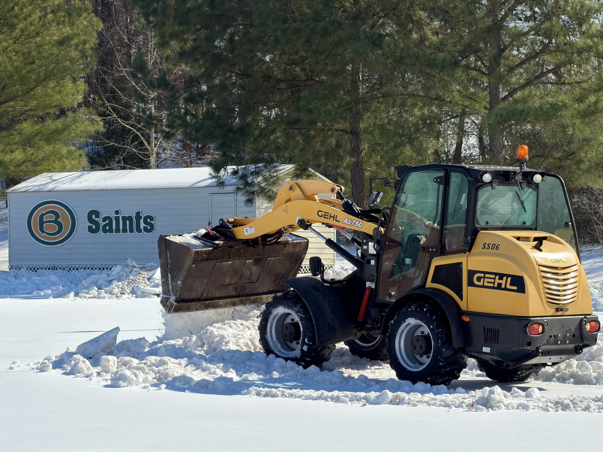 Green Earth loader clearing snow from a commercial lot at Briarcrest in Memphis, TN