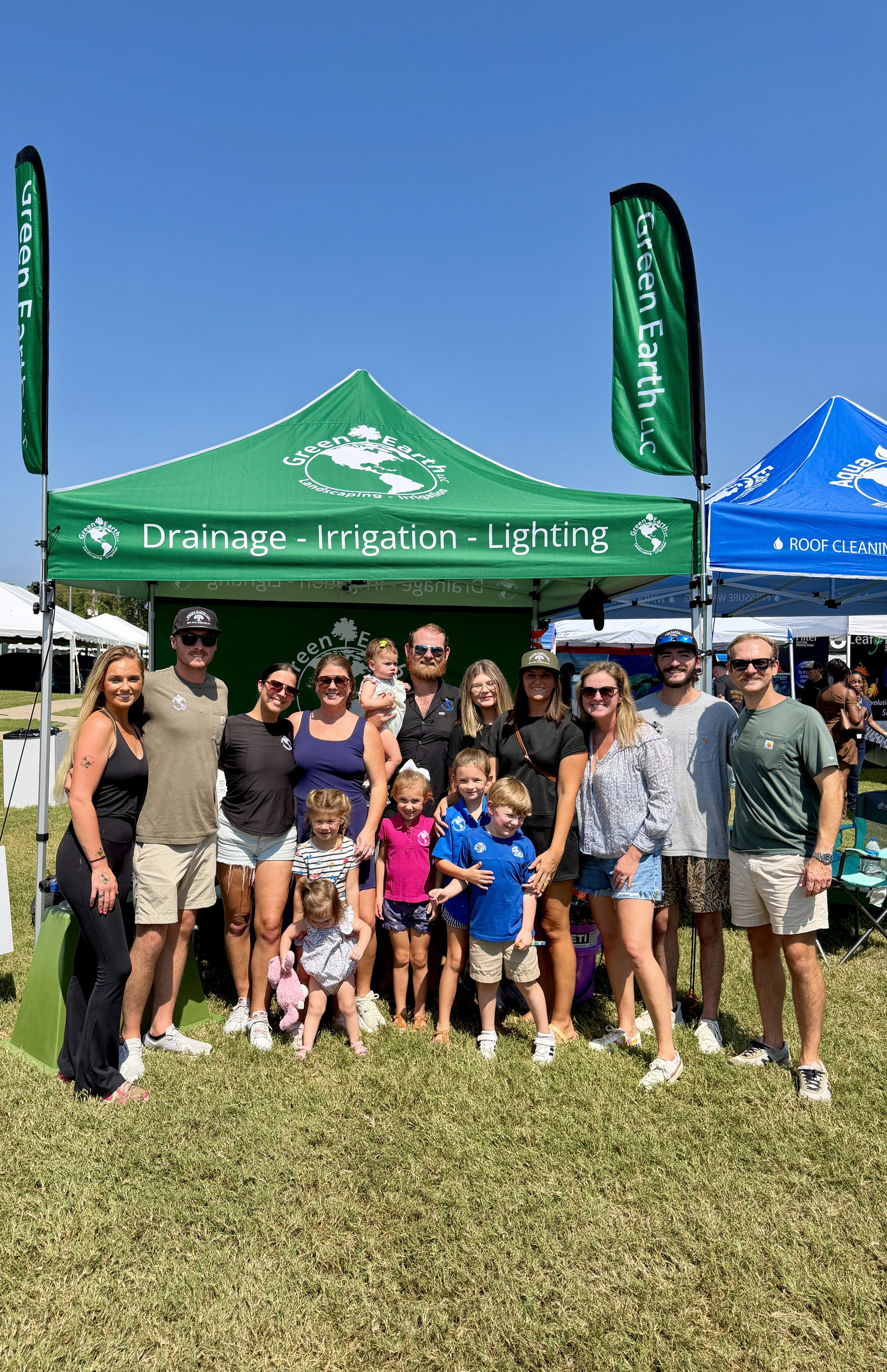 Green Earth team and families posing in front of the Green Earth tent at Germantown Festival 2026