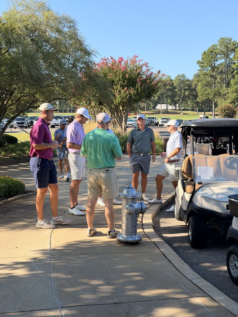 Green Earth team on a golf course near golf carts